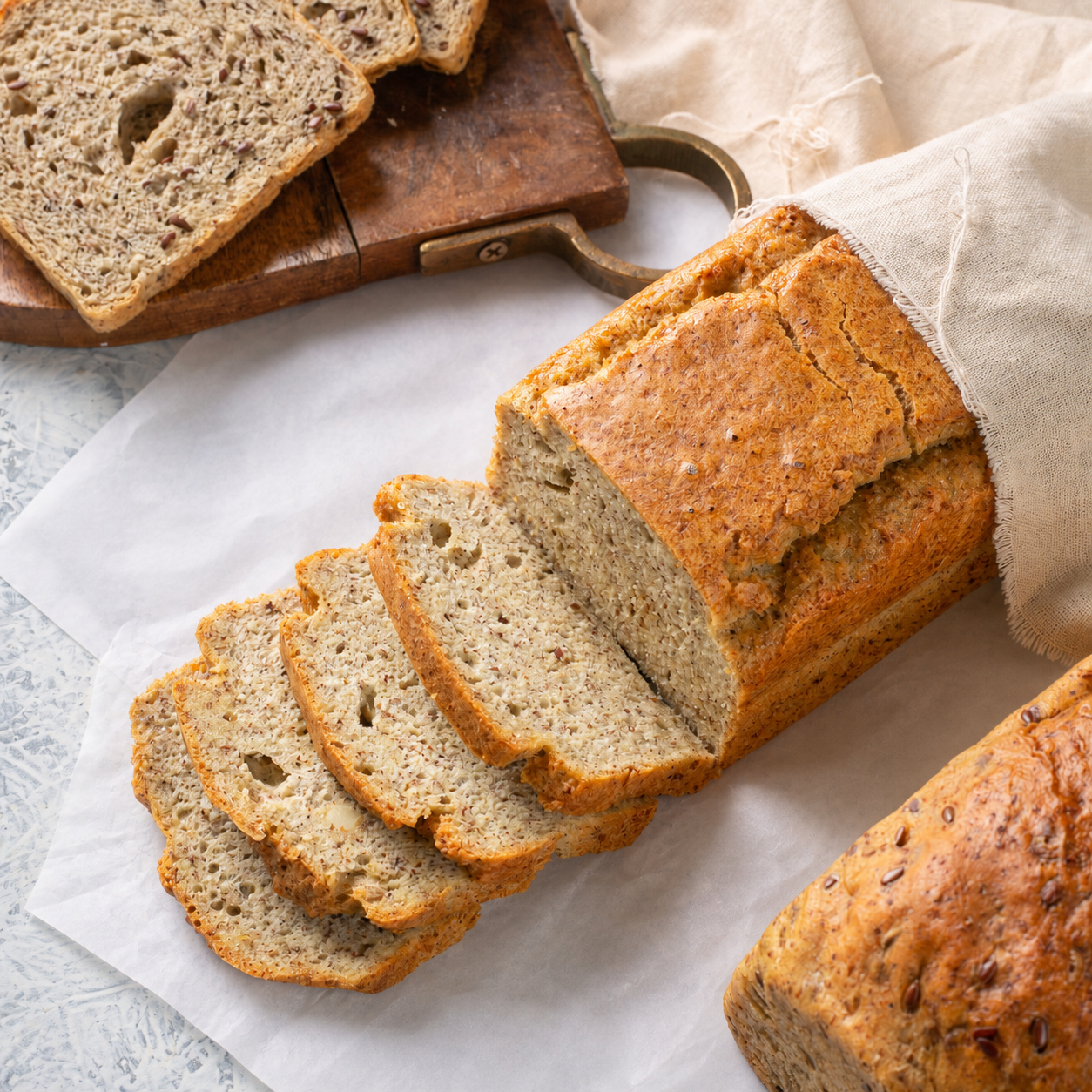 Gluten-free almond and flax seed bread sliced on parchment