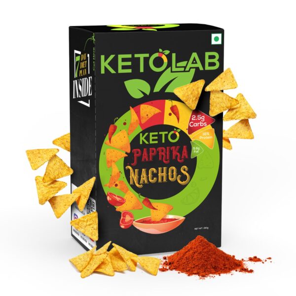 Front of Ketolab Paprika Nachos box with nacho chips and paprika spice powder arranged around the packaging. Label highlights include 2.5g carbs, 18% protein, and 5.6g fat.
