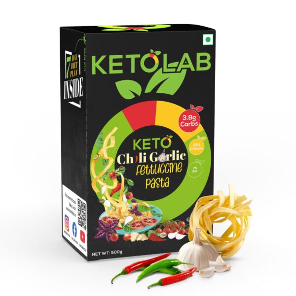 Ketolab Chili Garlic Fettuccine Pasta box with fresh garlic cloves, red and green chilies, and fettuccine noodles placed in front.
